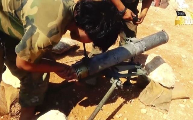 This frame grab from video provided in August 6, 2016, by the Turkistan Islamic Party shows a fighter from the militant group preparing to fire a missile during a battle against Syrian government forces in Aleppo, Syria. (Turkistan Islamic Party website via AP) This frame grab from video provided in August 6, 2016, by the Turkistan Islamic Party shows a fighter from the militant group preparing to fire a missile during a battle against Syrian government forces in Aleppo, Syria. (Turkistan Islamic Party website via AP)