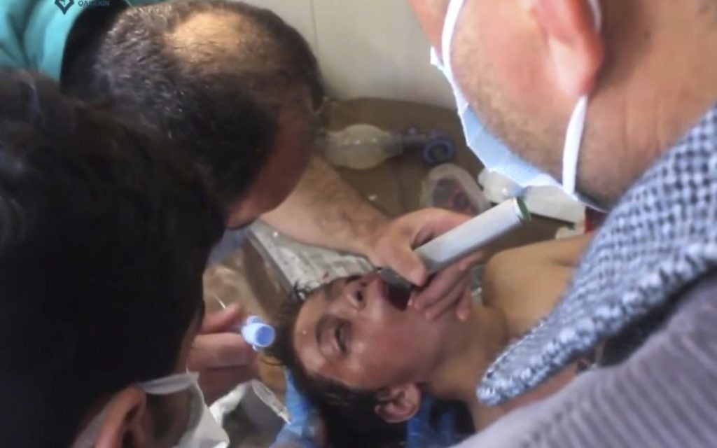 A Syrian doctor treating a boy following a suspected chemical attack, in the town of Khan Sheikhoun, northern Idlib province, Syria, from video provided on April 4, 2017. (Screen shot, Qasioun News Agency, via AP)