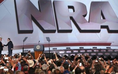 President Donald Trump, left, shakes hands with National Rifle Association Executive Vice President Wayne LaPierre as he arrives for the National Rifle Association Leadership Forum, Friday, April 28, 2017, in Atlanta. (Curtis Compton/Atlanta Journal-Constitution via AP)