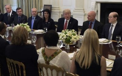 President Donald Trump, sitting next to US Ambassador to the UN Nikki Haley, speaks during a working lunch with ambassadors of countries on the United Nations Security Council and their spouses, April 24, 2017, in the State Dining Room of the White House in Washington. (AP/Susan Walsh)