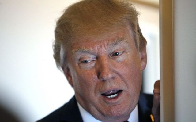 President Donald Trump speaks with reporters on Air Force One while in flight from Andrews Air Force Base, Md., to Palm Beach International Airport, Fla., Thursday, April 6, 2017. (AP Photo/Alex Brandon)