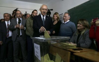 Leader of Turkey's main opposition Republican People's Party (CHP) Kemal Kilicdaroglu, center, casts a ballot inside a polling station in Ankara, on Sunday, April 16, 2017. (AP/Burhan Ozbilici)