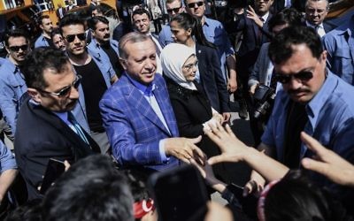 Turkey's President Recep Tayyip Erdogan and his wife Emine greet supporters as they leave a polling station in Istanbul, on Sunday, April 16, 2017. (AP Photo)