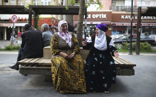 Two women chat as they sit in a boulevard in Diyarbakir, Turkey, Monday, April 17, 2017. Turkey's main opposition party urged the country's electoral board Monday to cancel the results of a landmark referendum that granted sweeping new powers to the nation's president, citing what it called substantial voting irregularities. (AP Photo/Emre Tazegul)