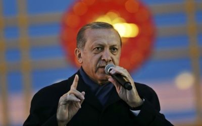 Turkey's President Recep Tayyip Erdogan delivers a speech during a rally of supporters a day after the referendum, outside the Presidential Palace, in Ankara, Turkey, Monday, April 17, 2017. (AP Photo/Burhan Ozbilici)