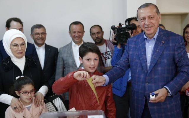 Turkey's President Recep Tayyip Erdogan, right, casts a ballot with his grandson, as wife Emine Erdogan, left, looks on, inside a polling station in Istanbul, Turkey, on Sunday, April 16, 2017. (AP/Lefteris Pitarakis) Turkey's President Recep Tayyip Erdogan, right, casts a ballot with his grandson, as wife Emine Erdogan, left, looks on, inside a polling station in Istanbul, Turkey, on Sunday, April 16, 2017. (AP/Lefteris Pitarakis)
