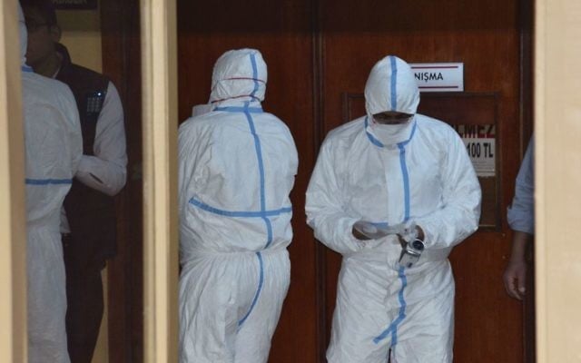In this photo taken on late Wednesday, April 5, 2017 and made available Thursday, April 6, World Health Organization experts take part in an autopsy conducted in a hospital in Adana, Turkey. (DHA-Depo Photos via AP)