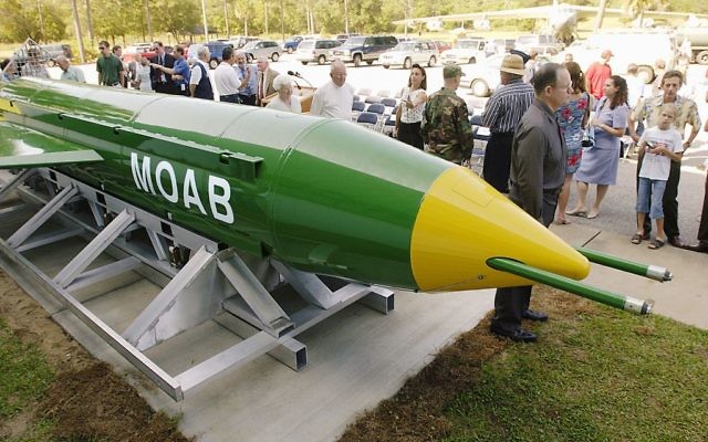 In this May 2004 photo, a group gathers around a GBU-43B, or massive ordnance air blast (MOAB) weapon, on display at the Air Force Armament Museum on Eglin Air Force Base near Valparaiso, Fla. (Mark Kulaw/Northwest Florida Daily News via AP)