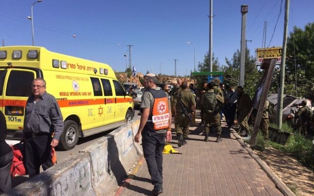 Medics and soldiers respond to a suspected car-ramming attack outside the Ofra settlement in the central West Bank on April 6, 2017. (Magen David Adom) Medics and soldiers respond to a suspected car-ramming attack outside the Ofra settlement in the central West Bank on April 6, 2017. (Magen David Adom)