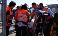 Medics treat an Israeli man who was lightly wounded in an apparent car-ramming attack in the West Bank's Gush Etzion Junction on April 19, 2017. (Magen David Adom)