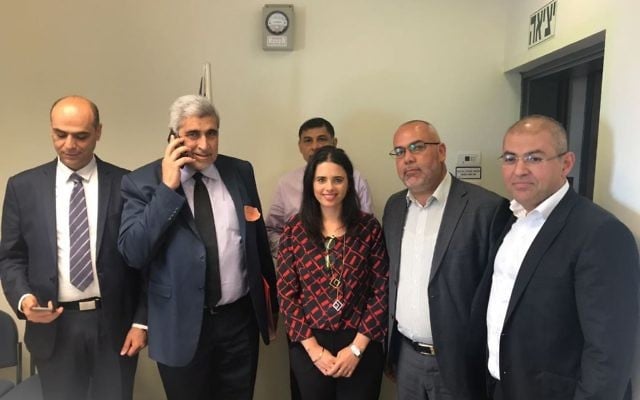 MK (Joint list) Osama Saadi stands to the right of Justice Minister Ayelet Shaked on April 25, 2017, after the two officials help appoint Israel's first female Sharia judge. (Courtesy) 