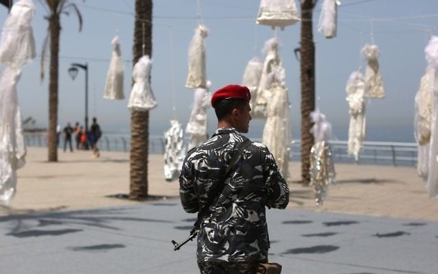 Lebanese activists use an installation of wedding dresses by Lebanese artist Mireille Honein at Beirut's Corniche to ramp up their campaign to press parliament to scrap Article 522 of Lebanon's penal code which allows rapists to escape punishement (AFP Photo/PATRICK BAZ)