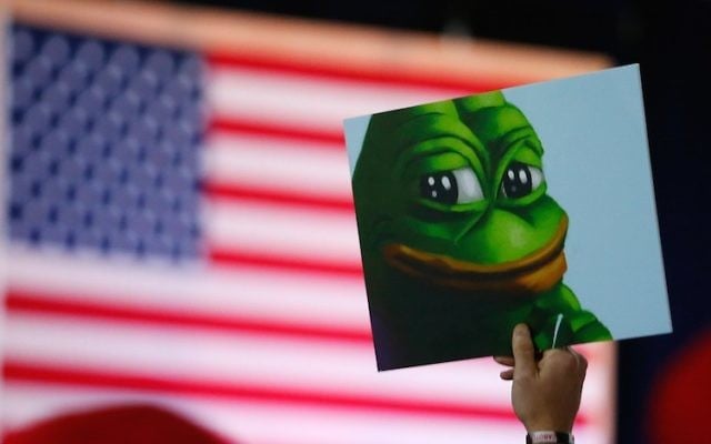 Illustrative: A Donald Trump supporter holds a poster of Pepe the Frog, a symbol of the alt-right movement, at a campaign event in Bedford, New Hampshire, on September 29, 2016. (Jessica Rinaldi/The Boston Globe via Getty Images/JTA) Illustrative: A Donald Trump supporter holds a poster of Pepe the Frog, a symbol of the alt-right movement, at a campaign event in Bedford, New Hampshire, on September 29, 2016. (Jessica Rinaldi/The Boston Globe via Getty Images/JTA)