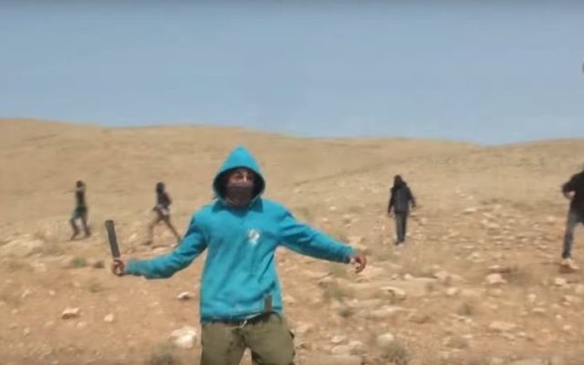 An attacker is seen lifting his bat just before attacking Rabbi Arik Asherman in the West Bank, on Friday, April 21 2017 (Screen capture YoTube) An attacker is seen lifting his bat just before attacking Rabbi Arik Asherman in the West Bank, on Friday, April 21 2017 (Screen capture YoTube)