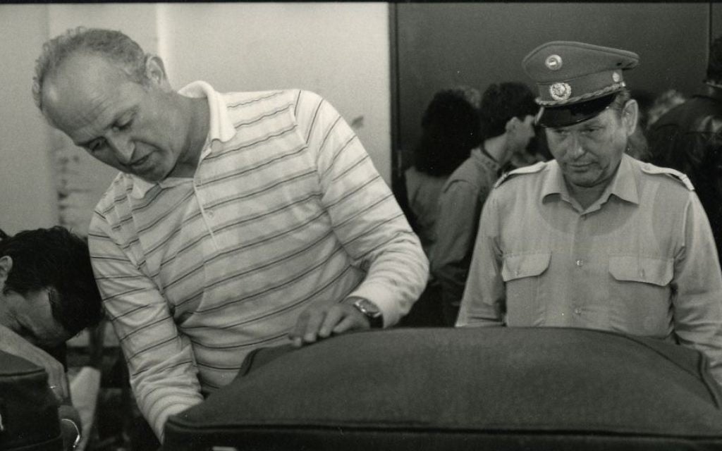 A Soviet customs official examines luggage. (Courtesy 'Stateless') A Soviet customs official examines luggage. (Courtesy 'Stateless')