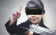 A young boy believed to be the eight-year-old son of Australian Islamic State fighter Khaled Sharrouf making threats against Australians in a home video. (Screen capture: YouTube)