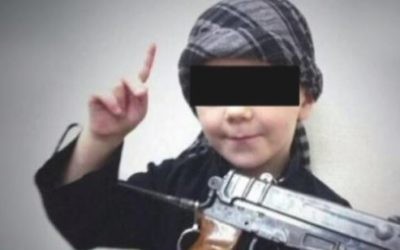 A young boy believed to be the eight-year-old son of Australian Islamic State fighter Khaled Sharrouf making threats against Australians in a home video. (Screen capture: YouTube)