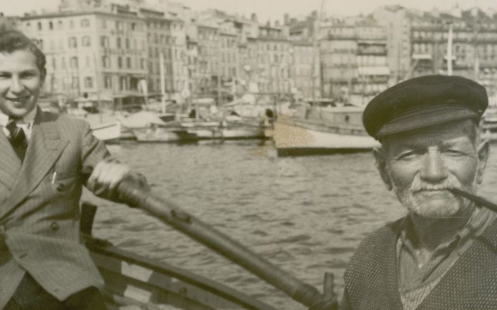 Justus Rosenberg, left, rowing a boat with a sailor. (Courtesy)