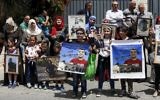 Families of Palestinians imprisoned in Israeli jails demonstrate in front of the European Union offices in East Jerusalem, April 27, 2017. (AFP/AHMAD GHARABLI)