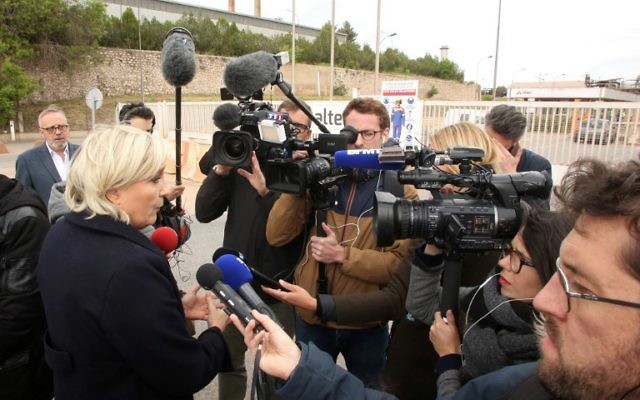 French presidential election candidate for the far-right Front National (FN) party Marine Le Pen (L) speaks to journalists in front of the Alteo aluminium plant in Gardanne, southern France, on April 30, 2017. AFP/ STRINGER) French presidential election candidate for the far-right Front National (FN) party Marine Le Pen (L) speaks to journalists in front of the Alteo aluminium plant in Gardanne, southern France, on April 30, 2017. AFP/ STRINGER)