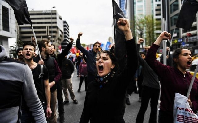 People gesture and chant slogans as they protest to defy a ban and march on the way to Taksim Square during the May Day rally, in Istanbul, on May 1, 2017. (AFP PHOTO / BULENT KILIC) People gesture and chant slogans as they protest to defy a ban and march on the way to Taksim Square during the May Day rally, in Istanbul, on May 1, 2017. (AFP PHOTO / BULENT KILIC)