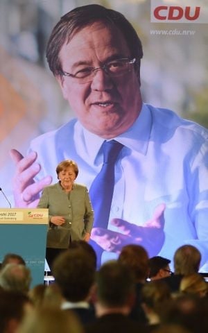 German chancellor Angela Merkel delivers her speech in front of a poster featuring Conservative Christian Democrats (CDU) leader in North Rhine-Westphalia Armin Laschet during a CDU campaign rally for state elections in North Rhine-Westphalia on May 5, 2017 in Bonn, western Germany. (Patrik Stollarz/AFP)