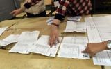 Scrutineers count votes at the end of the Algerian parliamentary elections late on May 4, 2017, in the capital Algiers. (AFP/Ryad Kramdi)