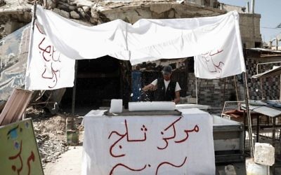 A Syrian man sells ice in the rebel-held town of Douma, on the eastern outskirts of Damascus on May 6, 2017. (Sameer Al-Doumy/AFP)