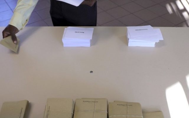 A man picks up his ballots to a polling station in Saint-Leu, on May 7, 2017, during the second round of the French presidential election. AFP/ Richard BOUHET) A man picks up his ballots to a polling station in Saint-Leu, on May 7, 2017, during the second round of the French presidential election. AFP/ Richard BOUHET)