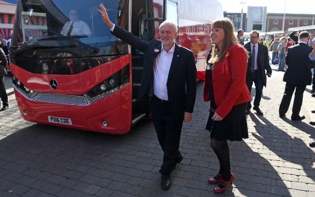 Britain's opposition Labour party Leader Jeremy Corbyn, center, waves to supporters as he is walks past a campaign bus in Ashton-under-Lyne, north-west England, May 9, 2017 (AFP/Paul ELLIS)