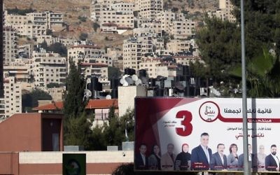 A picture taken on May 10, 2017 in the northern West Bank city of Nablus shows a campaign billboard displaying an electoral list ahead of municipal elections. (AFP/Jaafar Ashtiyeh)
