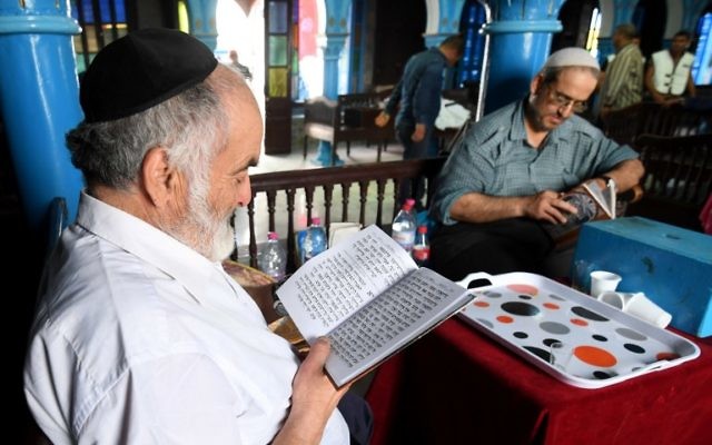 Rabbi Daoud (L) reads the Torah at the Ghriba synagogue in the Tunisian resort island of Djerba on May 12, 2017 during the first day of the annual Jewish pilgrimage to the synagogue on Tunisia's Mediterranean resort island of Djerba. (Fethi Belad/AFP) Rabbi Daoud (L) reads the Torah at the Ghriba synagogue in the Tunisian resort island of Djerba on May 12, 2017 during the first day of the annual Jewish pilgrimage to the synagogue on Tunisia's Mediterranean resort island of Djerba. (Fethi Belad/AFP)