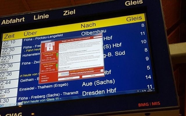 A window announcing the encryption of data including a requirement to pay appears on an electronic timetable display at the railway station in Chemnitz, eastern Germany, on May 12, 2017. (AFP PHOTO / dpa / P. GOETZELT) A window announcing the encryption of data including a requirement to pay appears on an electronic timetable display at the railway station in Chemnitz, eastern Germany, on May 12, 2017. (AFP PHOTO / dpa / P. GOETZELT)