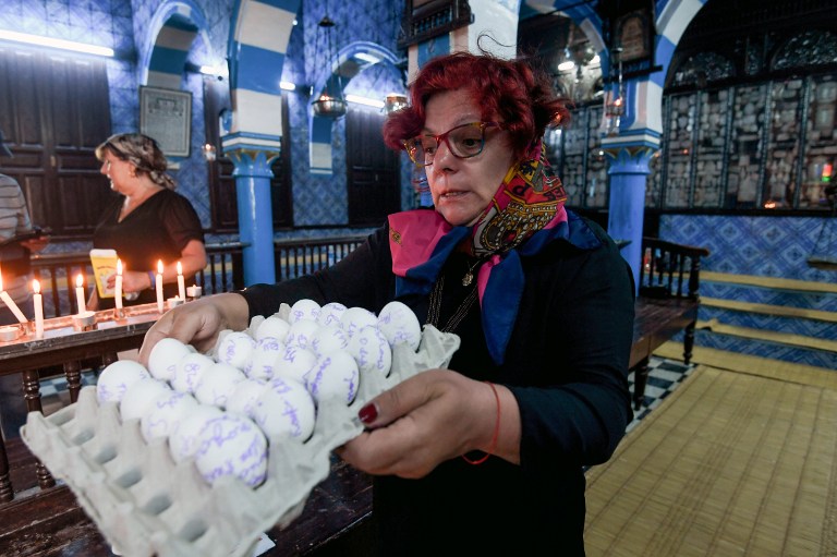 A French Jewish woman carries a carton of eggs with her family's wishes written on them at the Ghriba Synagogue on the Tunisian resort island of Djerba on May 14, 2017 during the second day of the annual Jewish pilgrimage to the synagogue thought to be Africa's oldest. (AFP PHOTO / FETHI BELAID) A French Jewish woman carries a carton of eggs with her family's wishes written on them at the Ghriba Synagogue on the Tunisian resort island of Djerba on May 14, 2017 during the second day of the annual Jewish pilgrimage to the synagogue thought to be Africa's oldest. (AFP PHOTO / FETHI BELAID)