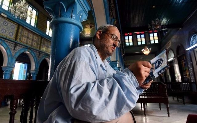 Tunisian Rabbi Daoud reads from a prayer book at the Ghriba Synagogue on the Tunisian resort island of Djerba on May 14, 2017, during the second day of the annual Jewish pilgrimage to the synagogue thought to be Africa's oldest. (FETHI BELAID / AFP) Tunisian Rabbi Daoud reads from a prayer book at the Ghriba Synagogue on the Tunisian resort island of Djerba on May 14, 2017, during the second day of the annual Jewish pilgrimage to the synagogue thought to be Africa's oldest. (FETHI BELAID / AFP)