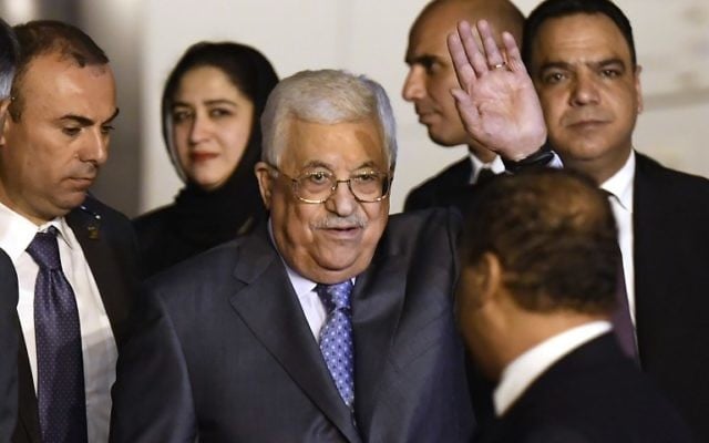 Palestine Authority President Mahmoud Abbas (C) waves as he walks with officials after arriving at Palam Air Force Station in New Delhi on May 14, 2017. AFP PHOTO / PRAKASH SINGH)