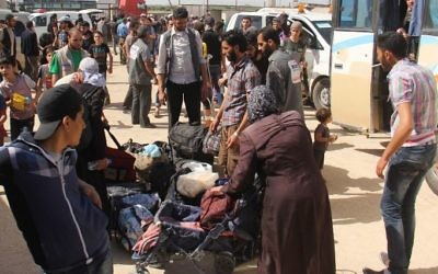 Syrian civilians and rebels, who were evacuated from the Qabun district in northeast Damascus, arrive at a temporary camp in the northern countryside of Idlib province on May 15, 2017. (AFP/Omar Haj Kadour)