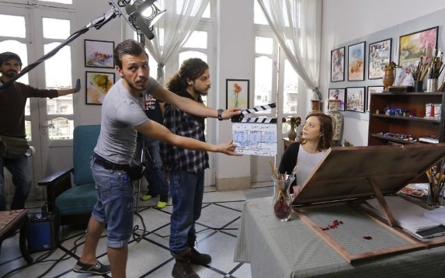 Syrian actress Nadine Tahseen Beck, right, is seen during the filming of the serial drama 'Fouda' or 'Chaos' in the al-Qasaa area near Damascus's Jobar district, which remains divided between rebel and government control and is a key front line in the capital, on May 13,2017 . (AFP/Louai Beshara)