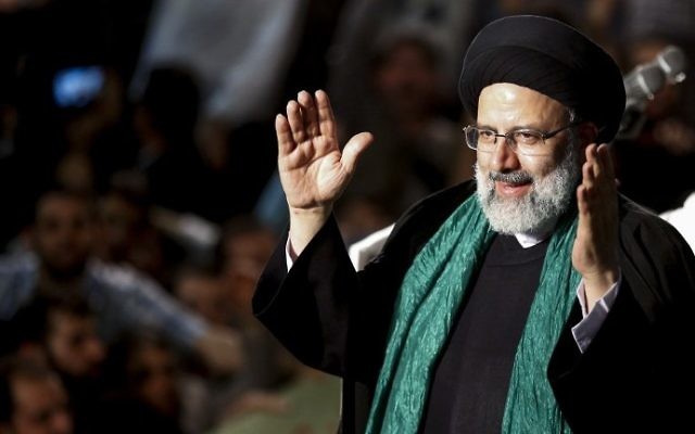 Iranian presidential candidate Ebrahim Raisi greets his supporters during a campaign rally at Imam Khomeini Mosque in the capital Tehran on May 16, 2017. (AFP Photo/Atta Kenare)