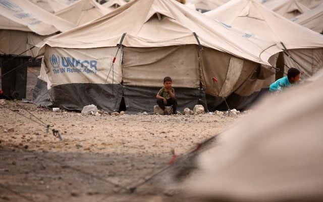 A displaced Syrian child, who fled the countryside surrounding the Islamic State group stronghold of Raqqa, sitting outside a tent at a temporary camp in the village of Ain Issa, Syria, May 1, 2017. (AFP/DELIL SOULEIMAN) A displaced Syrian child, who fled the countryside surrounding the Islamic State group stronghold of Raqqa, sitting outside a tent at a temporary camp in the village of Ain Issa, Syria, May 1, 2017. (AFP/DELIL SOULEIMAN)