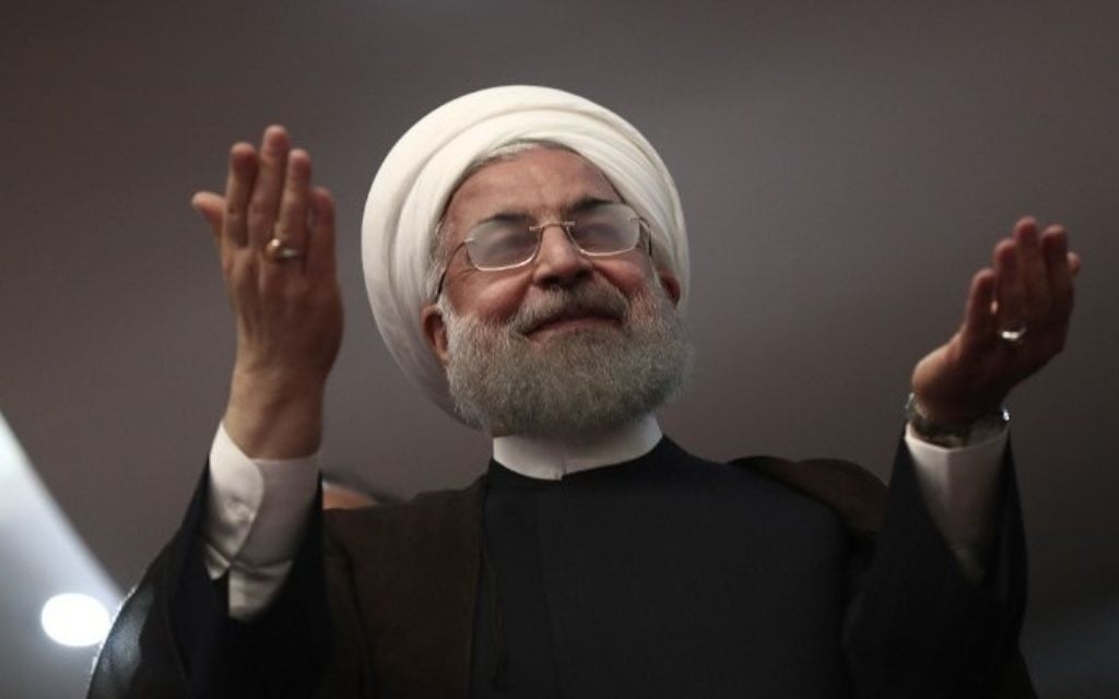 Iranian President and candidate in the upcoming presidential elections Hassan Rouhani gestures during a campaign rally in the northwestern city of Ardabil on May 17, 2017. (AFP Photo/Behrouz Mehri)