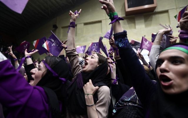 Supporters of Iranian President and candidate in the upcoming presidential elections, Hassan Rouhani, attend a campaign rally in the northwestern city of Ardabil on May 17, 2017. (AFP PHOTO / Behrouz MEHRI) Supporters of Iranian President and candidate in the upcoming presidential elections, Hassan Rouhani, attend a campaign rally in the northwestern city of Ardabil on May 17, 2017. (AFP PHOTO / Behrouz MEHRI)