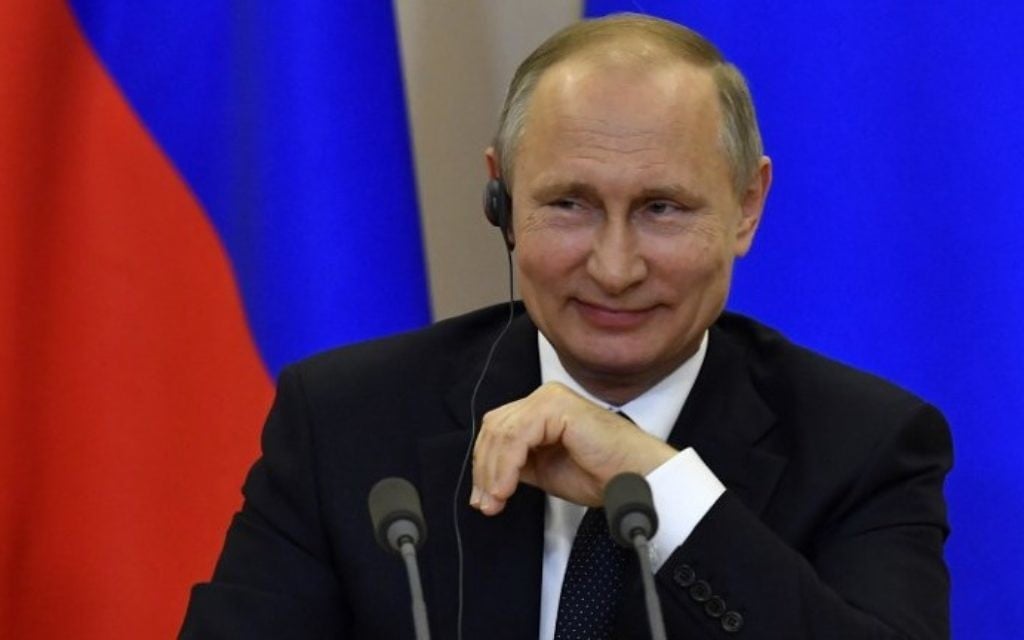 Russian President Vladimir Putin smiles during a joint press conference with Italian Prime Minister following their meeting at the Bocharov Ruchei state residence in Sochi on May 17, 2017.  (AFP PHOTO / POOL / Yuri KADOBNOV)
