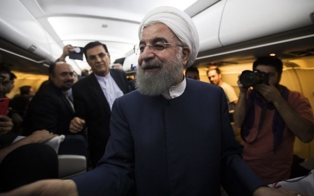 Iranian President Hassan Rouhani greets reporters and photographers during a flight from northeastern city of Mashhad to Tehran late on May 17, 2017. (AFP Photo/Behrouz Mehri) Iranian President Hassan Rouhani greets reporters and photographers during a flight from northeastern city of Mashhad to Tehran late on May 17, 2017. (AFP Photo/Behrouz Mehri)
