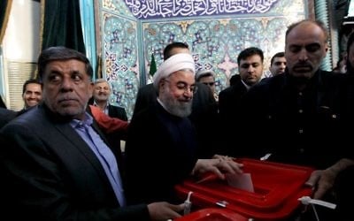 Iranian President and presidential candidate, Hassan Rouhani, casts his ballot for the presidential elections at a polling station in Tehran on May 19, 2017. (Majid Azad/AFP)