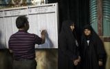 An Iranian man checks the list of municipal council elections ahead of voting at a polling station in Tehran on May 19, 2017. / AFP PHOTO / Behrouz MEHRI