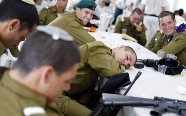 IDF soldiers assigned to US President Donald Trump's welcoming ceremony honor guard rest ahead of the arrival of the president and First Lady Melania Trump at Ben Gurion International Airport on May 22, 2017. (AFP Photo/Jack Guez)
