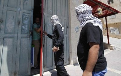Palestinian Fatah movement supporters speak to a shop owner as they roam the streets of the West Bank town of Bethlehem to monitor a general strike called for by activists throughout the Palestinian territories and among Arab Israelis, in support of Palestinian prisoners on hunger-strike in Israeli jails, May 22, 2017. (AFP/Musa AL SHAER)