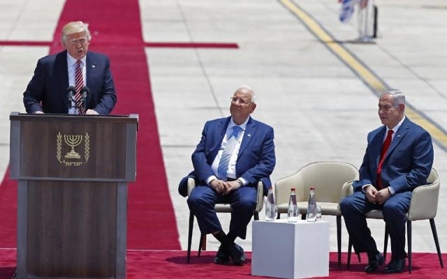 US President Donald Trump speaks as Israeli President Reuven Rivlin and Israeli Prime Minister Benjamin Netanyahu (R) listen upon Trump's arrival at Ben Gurion International Airport in Tel Aviv on May 22, 2017, as part of his first trip overseas. (AFP PHOTO / Jack GUEZ)
