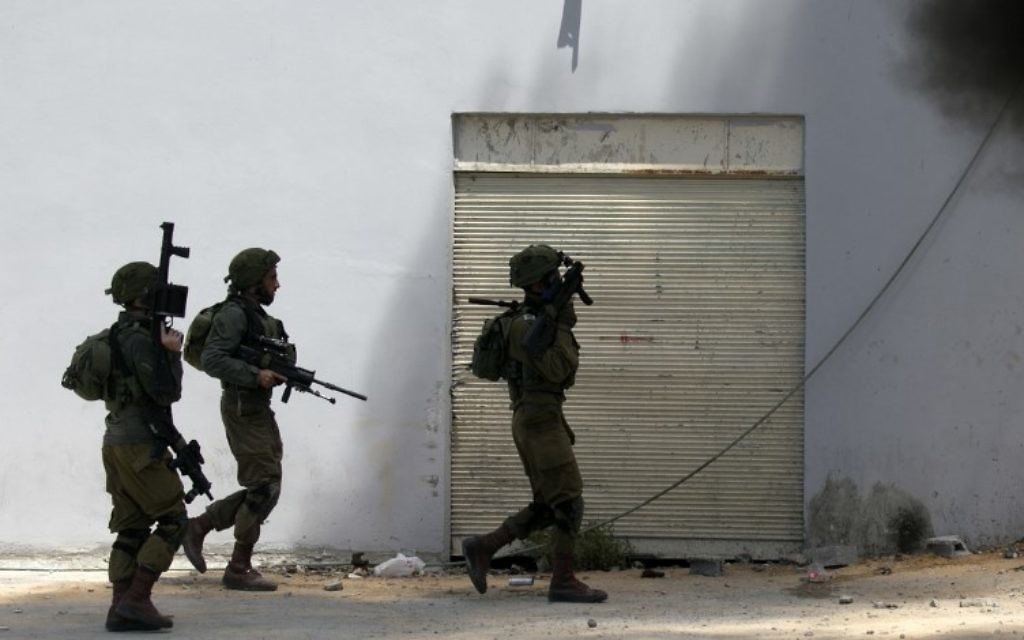 File: Israeli soldiers in a West Bank village, on May 22, 2017, in Dayr Sharaf, west of Nablus. (AFP Photo/Jaafar Ashtiyeh)